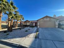 Single-story house with desert landscaping and a two-car garage at 1551 Leatherleaf Dr, Las Vegas, NV 89123