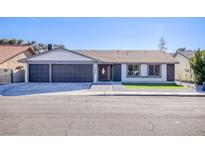 Newly renovated single-story home with a two-car garage and landscaped front yard at 1943 Hallwood Dr, Las Vegas, NV 89119