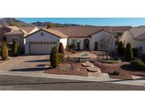 Charming single-story home showcasing a well-maintained yard, stone accents, and a two-car garage at 2204 Twin Falls Dr, Henderson, NV 89044