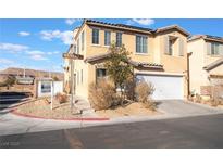 Two-story house with attached garage and desert landscaping at 5695 Merced St, Las Vegas, NV 89148