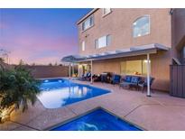 Inviting backyard pool and patio area perfect for entertaining and relaxation at 6595 Creekside Cellars Ct, Las Vegas, NV 89139