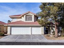 Two-story house with a three-car garage and desert landscaping at 7628 Tortola Bay Ln, Las Vegas, NV 89128