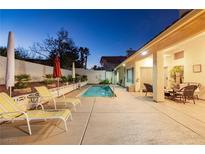 Inviting backyard with refreshing pool, lounge chairs, and covered patio perfect for relaxing at the end of the day at 9109 Lazy Hill Cir, Las Vegas, NV 89117