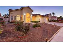 Beautiful desert landscaping surrounds this single-story home with a three-car garage at 9109 Lazy Hill Cir, Las Vegas, NV 89117