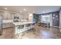 Modern kitchen with island, stainless steel appliances, and ample cabinet space at 9888 Abel Cliff St, Las Vegas, NV 89143