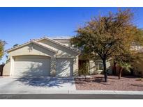 Two-story house with a three-car garage and landscaped front yard at 10500 Eagle Nest St, Las Vegas, NV 89141