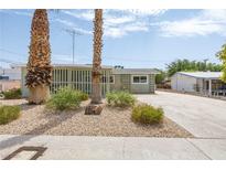 Ranch style home with a landscaped front yard and spacious driveway at 1105 I, Boulder City, NV 89005