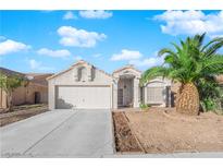 Single-story house with attached garage and desert landscaping at 1320 Indian Hedge Dr, North Las Vegas, NV 89032