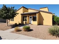 Tan two-story house with white door, landscaping, and gravel driveway at 1480 Hialeah Dr # B, Las Vegas, NV 89119