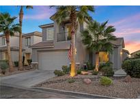 Two-story house with gray siding, palm trees, and a well-manicured front yard at 2465 Sturrock Dr, Henderson, NV 89044