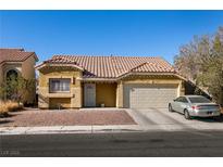 Single-story house with a two-car garage and desert landscaping at 2535 River Oaks Dr, Las Vegas, NV 89156