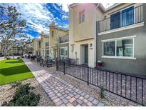 Charming townhome featuring a private patio, lush landscaping, and a well-maintained walkway leading to the entrance at 2598 Mocha Pearl Ct, North Las Vegas, NV 89086