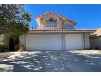 Two-story house with a three-car garage and landscaping at 2849 Huber Heights Dr, Las Vegas, NV 89128