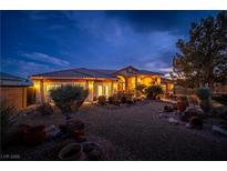 Single-story home with desert landscaping, lighting, and large front yard at 3361 Winery Rd, Pahrump, NV 89048