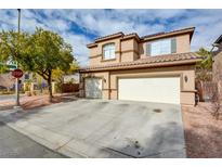 Two-story house with a three-car garage and landscaped front yard at 3402 Arcata Point Ave, Las Vegas, NV 89141