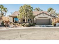 Single-story home with landscaped yard and two-car garage at 493 Lace Haven Ct, Henderson, NV 89012