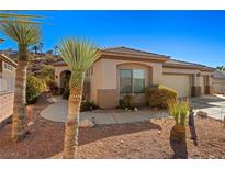 Single-story home with desert landscaping and attached two-car garage at 526 Highland View Ct, Mesquite, NV 89027