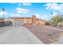 Ranch style home with attached garage and landscaped yard at 6205 Hargrove Ave, Las Vegas, NV 89107