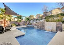 Inviting pool with waterfall feature and spacious patio area at 651 Penshaw Bridge Ave, Las Vegas, NV 89178