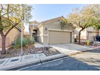 Two-story house with attached garage and desert landscaping at 8789 Ashley Park Ave, Las Vegas, NV 89148