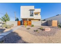 Modern two-story home with wood gate and landscaped yard at , Las Vegas, NV 89104