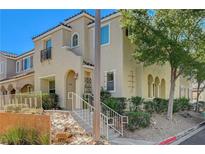 Two-story house with stucco exterior, Spanish-style architecture, and landscaping at 1032 Campo Seco Ct, Las Vegas, NV 89138