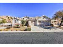 Single-story house with a two-car garage and desert landscaping at 1248 Abadan St, Las Vegas, NV 89142