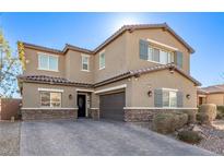 Two-story house with gray shutters, stone accents, and a paved driveway at 1413 Fantastic Ct, North Las Vegas, NV 89081