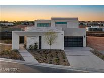 Modern two-story home with attached garage and landscaped front yard at 168 Still Shores St, Henderson, NV 89011