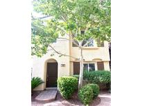 Two-story house with brown door and landscaping at 1880 Hollywell St, Las Vegas, NV 89135