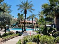 Inviting community pool with palm trees and lounge chairs at 220 E Flamingo Rd # 318, Las Vegas, NV 89169