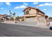 Two-story house with a large garage and well-maintained landscaping at 4726 Beaconsfield St, Las Vegas, NV 89147