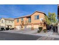 Tan two-story townhome with attached garage and landscaping at 6255 W Arby Ave # 295, Las Vegas, NV 89118