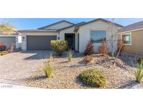 Single-story home with landscaped front yard and two-car garage at 6524 Summershade St, North Las Vegas, NV 89086