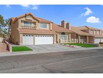 Two-story house with a three-car garage and landscaped front yard at 8232 Ocean Terrace Way, Las Vegas, NV 89128