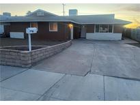 Cozy single-story home with a well-maintained front yard, a long driveway and a white mailbox at 929 Center St, Henderson, NV 89015