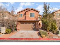 Two-story house with tan exterior, two-car garage, and landscaping at 1512 Groom Ave, North Las Vegas, NV 89081