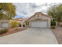 Single-story home with attached garage and landscaped front yard at 2400 Stadler Ct, Las Vegas, NV 89134