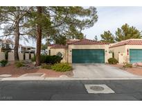 Single story home with green garage door and mature landscaping at 2714 Bridgepointe Dr, Las Vegas, NV 89121