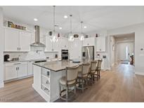 Spacious kitchen with island, stainless steel appliances, and white cabinetry at 3018 Fall Solstice Ct, Las Vegas, NV 89138