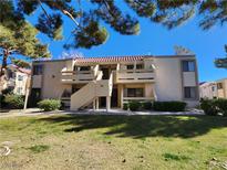 Two-story building with Spanish tile roofs, balconies, and a grassy yard at 3800 Desert Marina Dr # 160, Laughlin, NV 89029