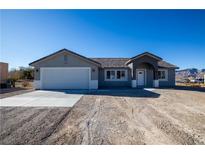 New single-story home with attached garage and neutral color scheme at 3960 Dart Dr, Pahrump, NV 89060