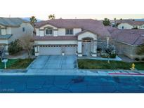 Two-story house with three-car garage and landscaped yard at 553 Sinfold Park St, Las Vegas, NV 89148