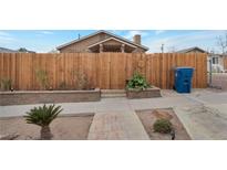 Inviting front yard with wooden fence and stone accents at 628 L, Boulder City, NV 89005