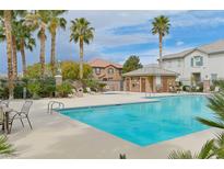 Inviting community pool with ample lounge chairs and a spa at 7322 Fools Gold St # 101, Las Vegas, NV 89149