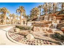 Gated community entrance with waterfall feature and lush landscaping at 768 Tozzetti Ln, Henderson, NV 89012