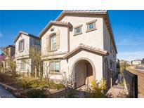 Two-story house with front yard landscaping and a brown door at 8034 Mercury Skye St, Las Vegas, NV 89166