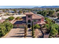 Gorgeous two-story home with a tile roof, three-car garage, and stone accents at 8490 Via De Bellasidra Ct, Las Vegas, NV 89123