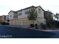 Tan two-story townhome with attached garage and driveway at , Las Vegas, NV 89118