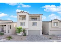 Two-story house with gray exterior, two-car garage, and balcony at 10375 Rose Palisade St, Las Vegas, NV 89141